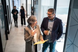 Businesspeople walking and talking in the office's corridor